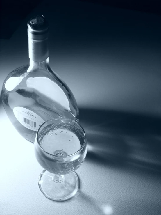 a bottle and a glass on a table