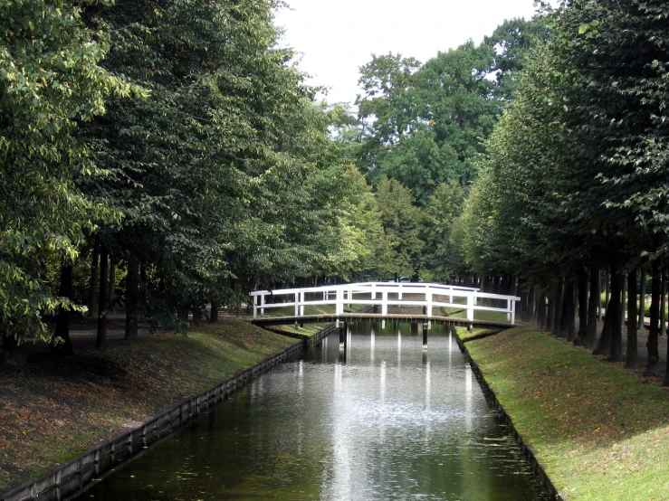 a small bridge spans the width of a creek