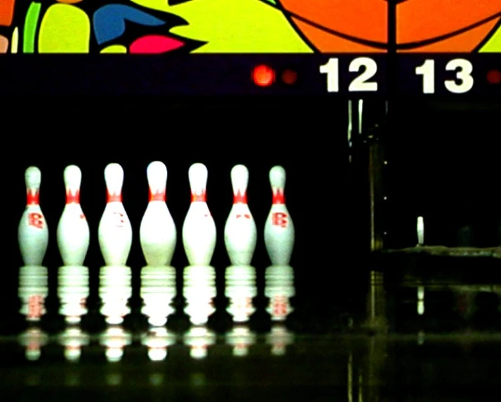 bowling pins and ball are sitting on the ground