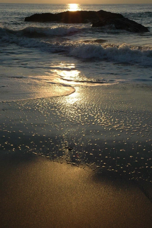 sunrise seen from the beach with sun setting on it