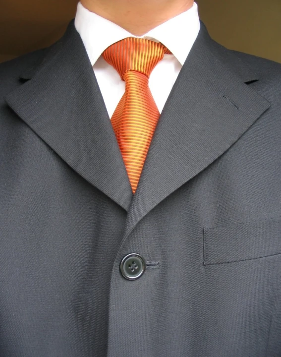 the suit coat is decorated with a striped tie