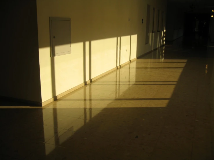 a white building with several doors and a sign in the middle