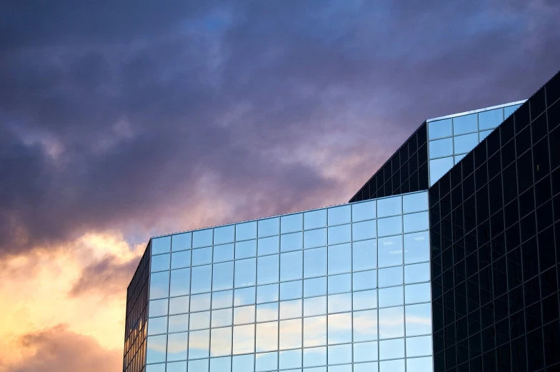 two tall buildings that have glass walls on each side