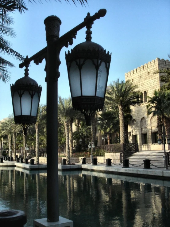 a couple of lamps that are on the side of a street