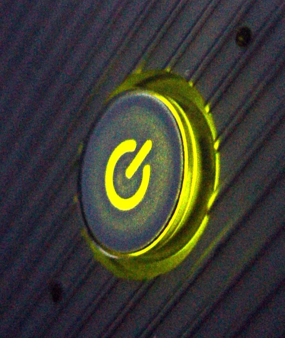 the top of a metal device with a light on