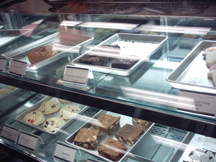 a display case of different desserts on a shelf