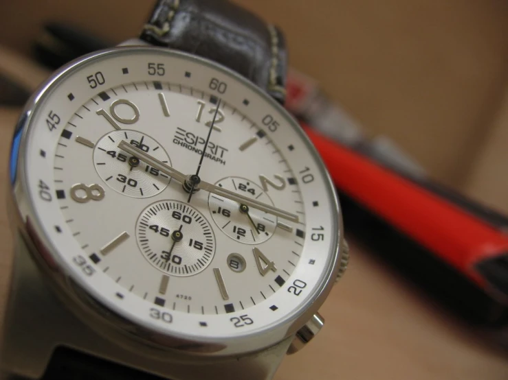 a watch sits on top of a piece of black and white material