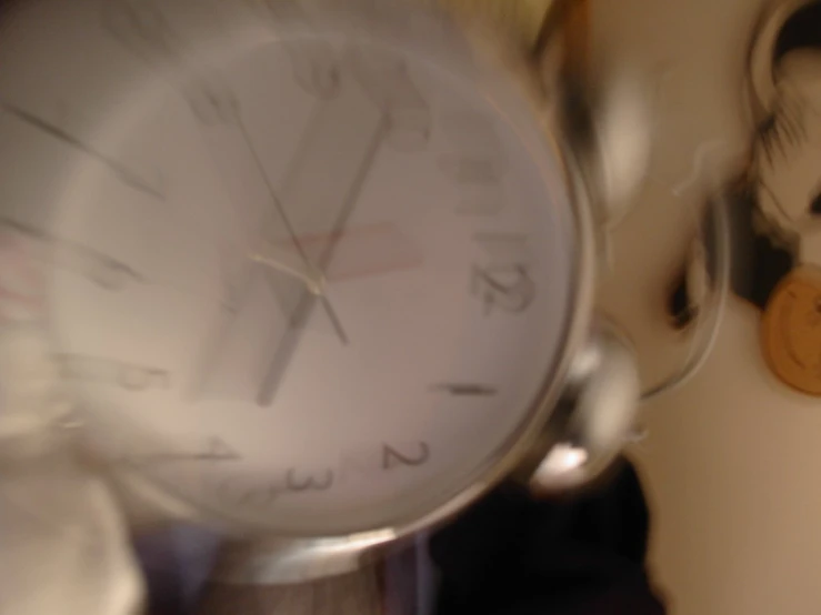 clock with hands on a silver table top