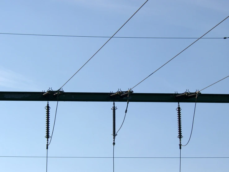 electric wires and wires suspended under a blue sky