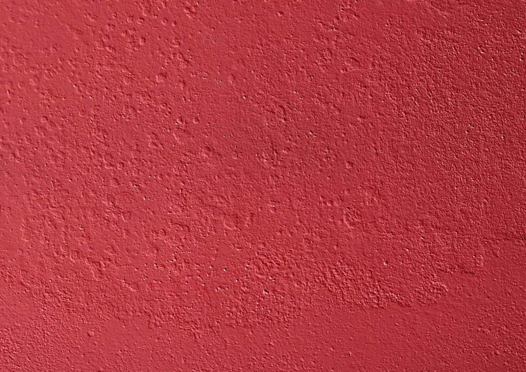 a textured red background that looks like concrete