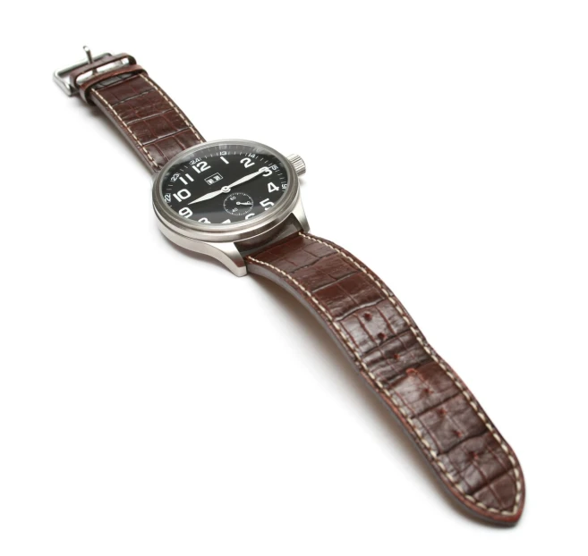 a watch with black face and brown leather band