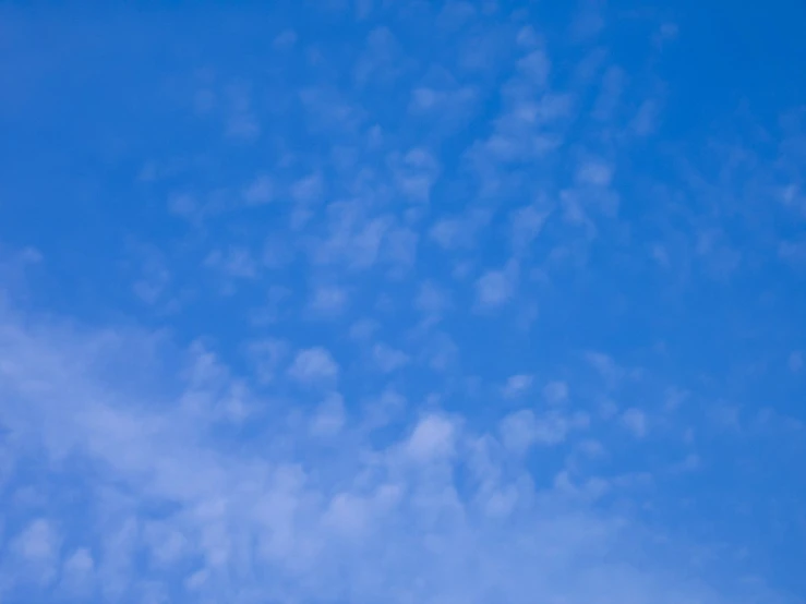 a plane is in the sky with clouds