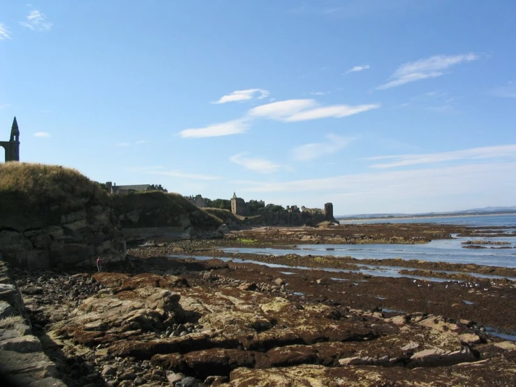 a rock wall stretches out towards the ocean