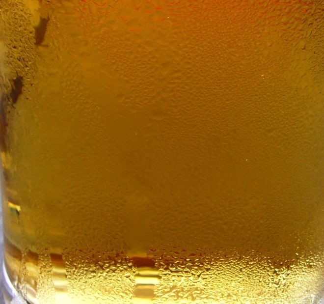 a glass filled with beer on top of a table