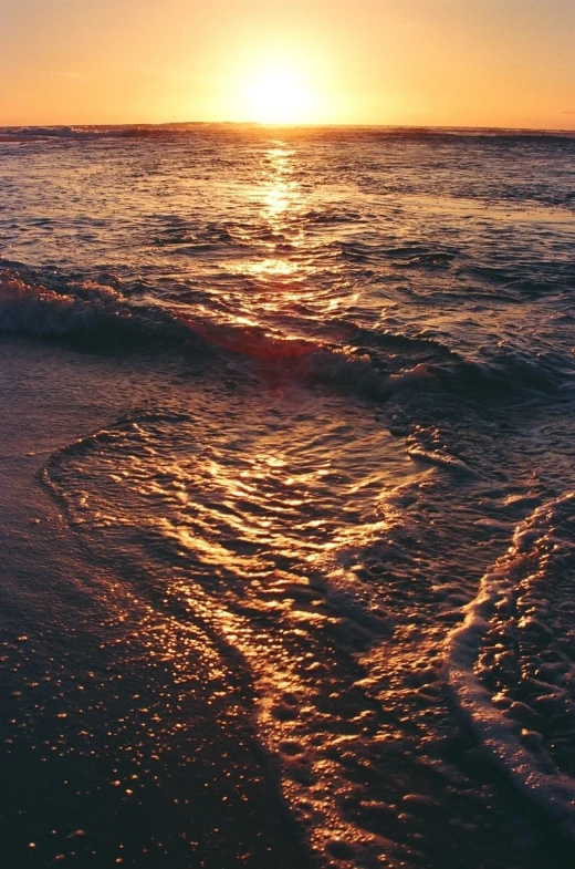 the sun shines on the ocean water