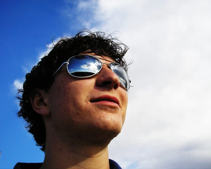a man with sunglasses looking up into the sky