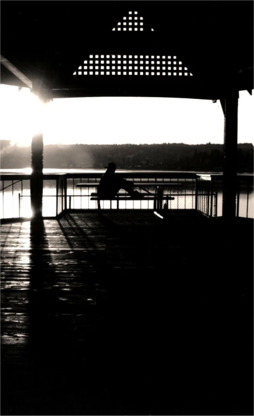 a man sitting on a bench with the light on