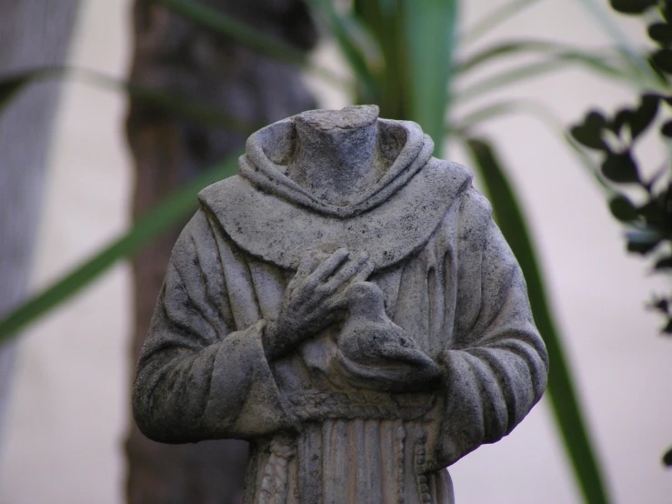 statue of a person with a hat and robe