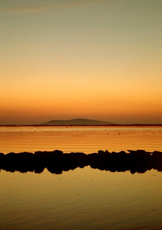 a po of the ocean in a sunset