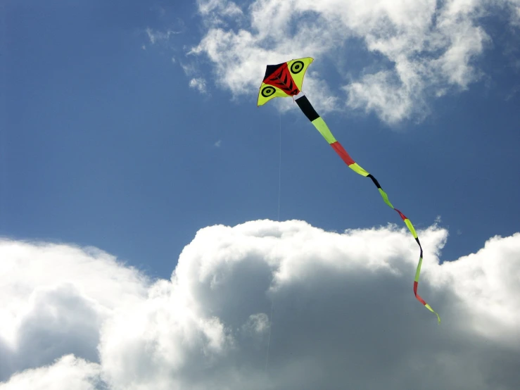 a large colorful kite being flown on the sky