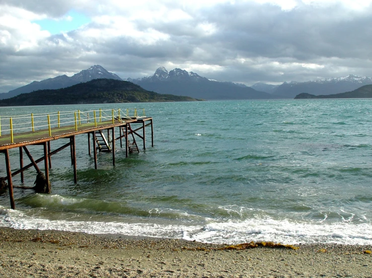 a very pretty and clean beach next to some water