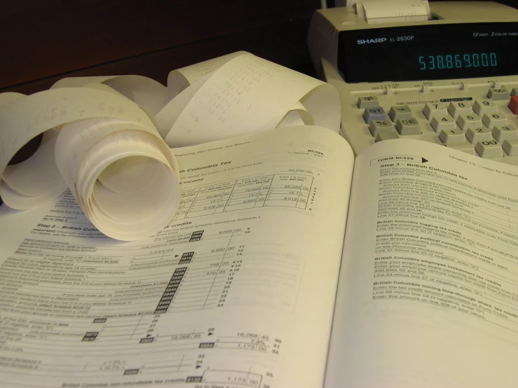 a table with papers and a calculator on it