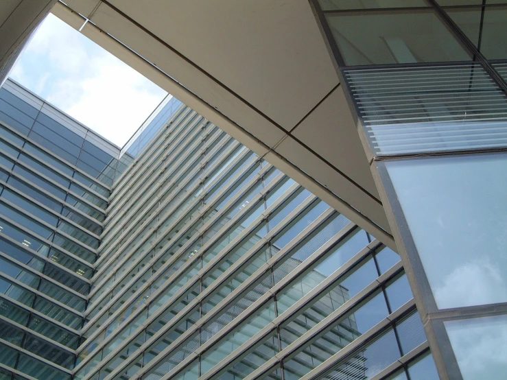 tall buildings reflected in glass windows on a cloudy day