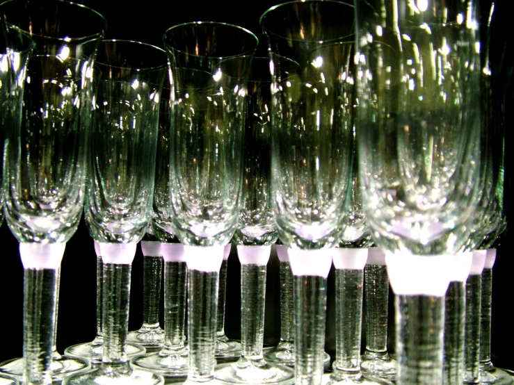 glasses are lined up for a toast to be served