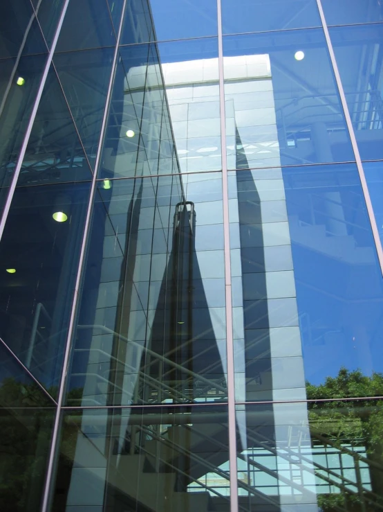 the reflection of an office building in a glass wall