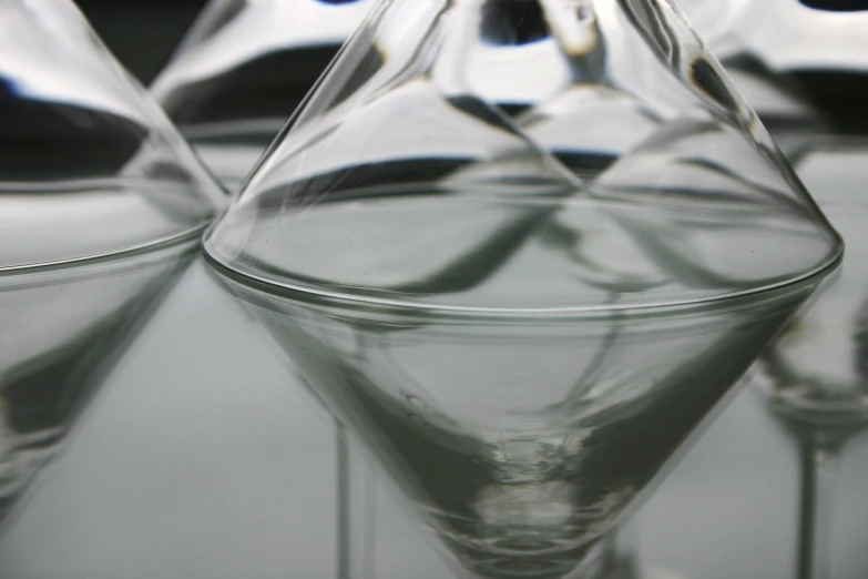 a close up of several upside down wine glasses