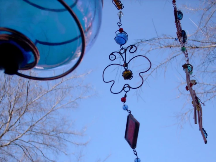 a collection of small wind chimes hanging from a tree