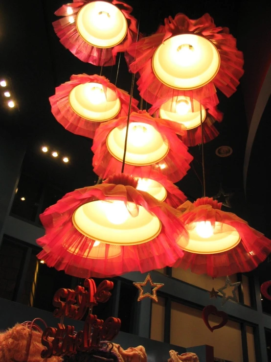 red and white umbrellas hung from ceiling in store