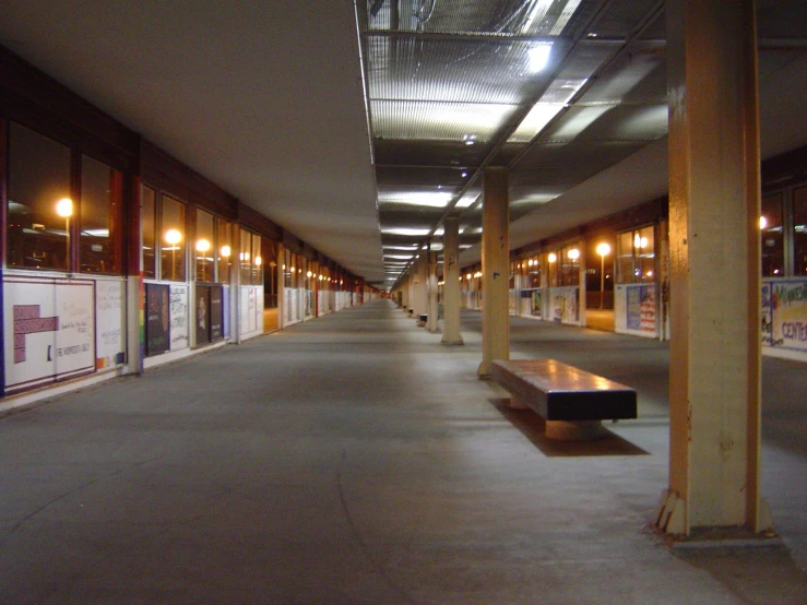 a hallway in an empty building with two benches