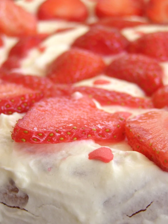 a cake topped with lots of strawberries on top of it