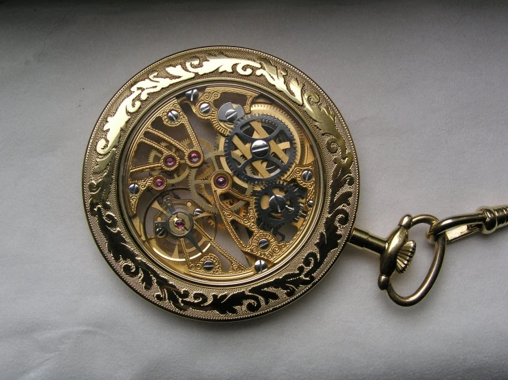 an antique watch with a key chain and pendant