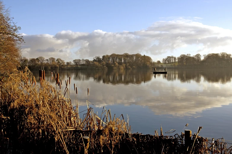 the water is calm with the dock in front