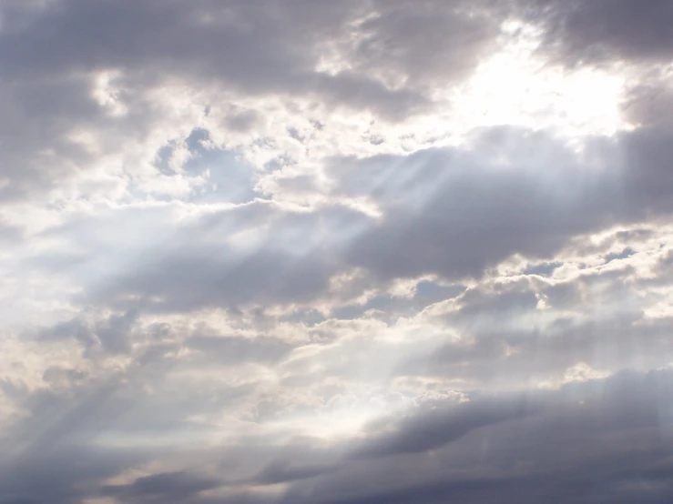 the bright light of an airplane can be seen through the clouds