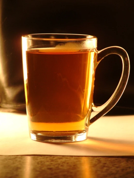 a mug of tea is seen sitting on a table