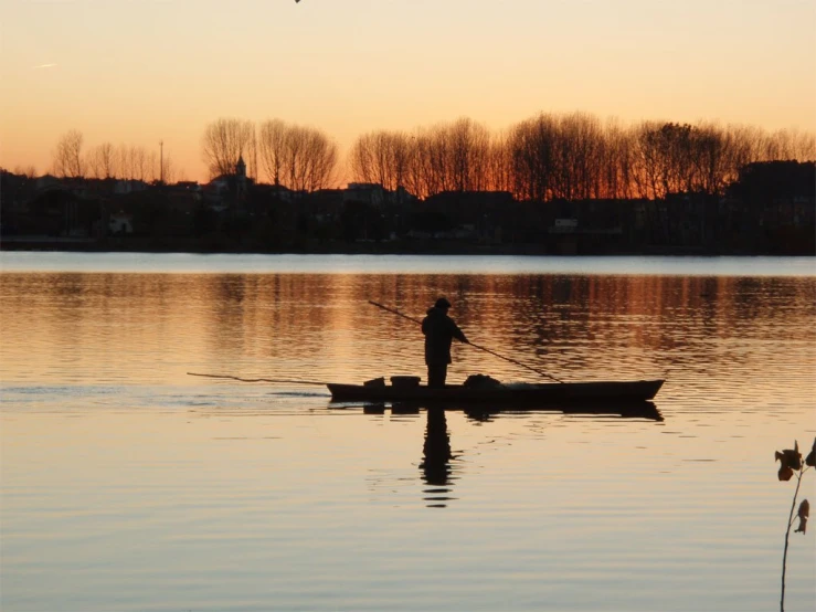 a person on a boat is rowing in the water