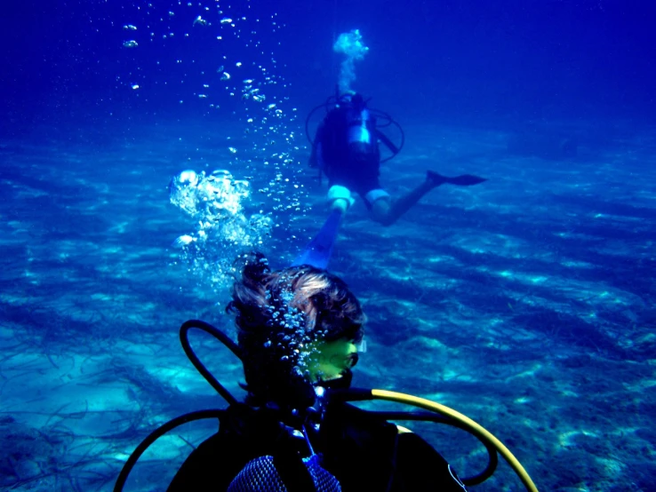 a person scubas with a camera in the water