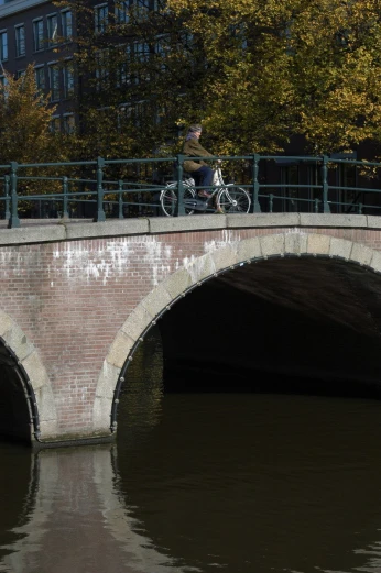there is a bicycle that is passing under a bridge