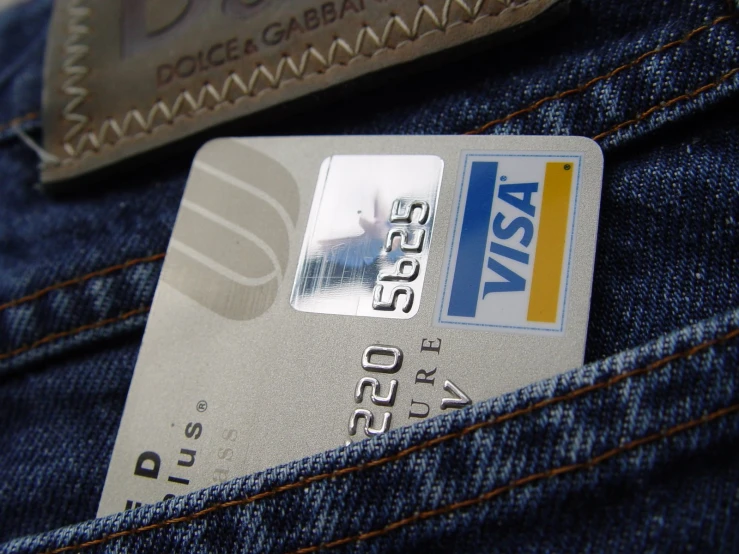 credit card on jeans pocket with credit card tucked into pocket