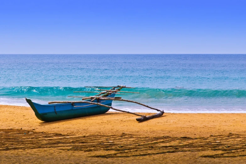 a rowboat is on the beach near the ocean