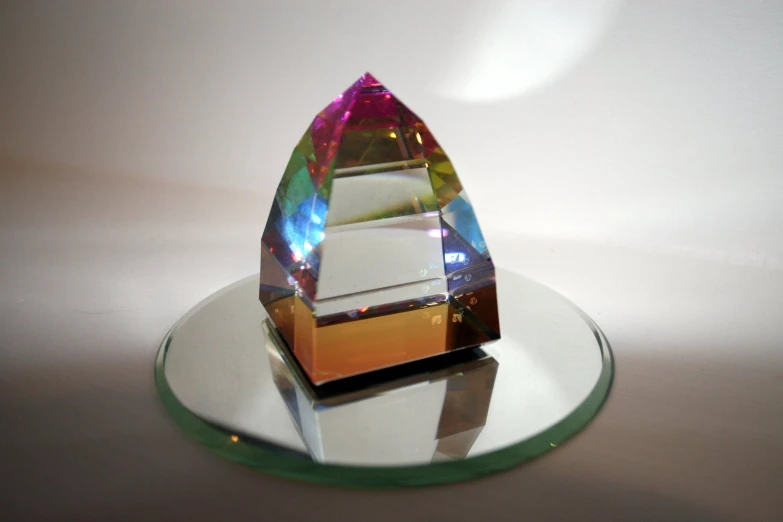 an unusual shaped piece of glass sits on a plate