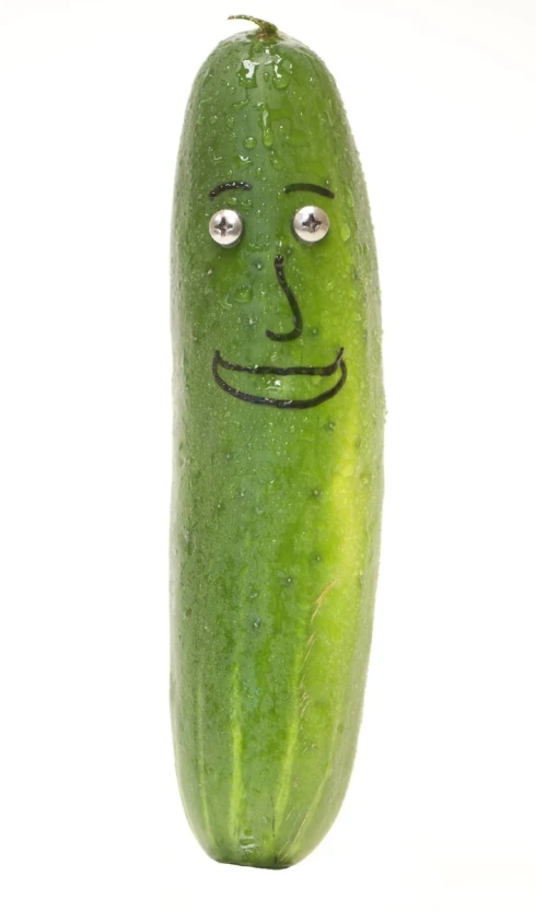 a green pickle with a funny face drawn on it