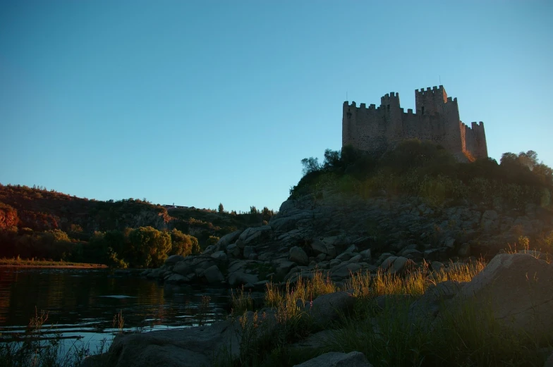 a castle with two towers next to the water