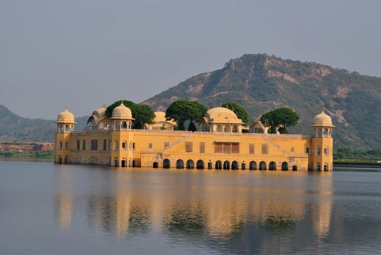 a yellow building that is sitting in the water