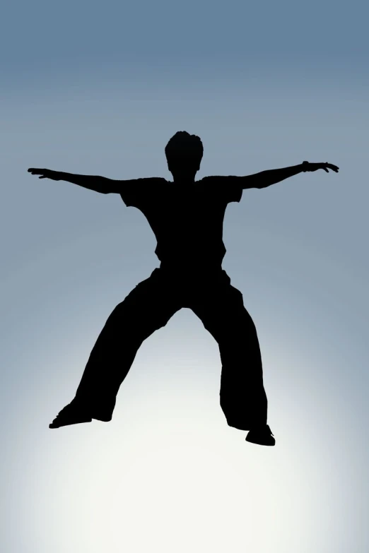 a silhouetted person doing a trick with his arms