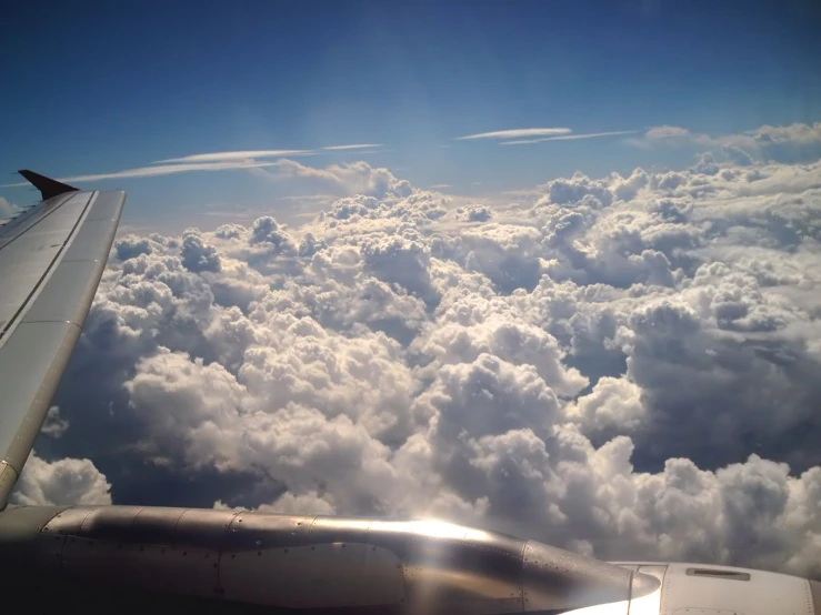 the view from inside the plane shows the wing and clouds