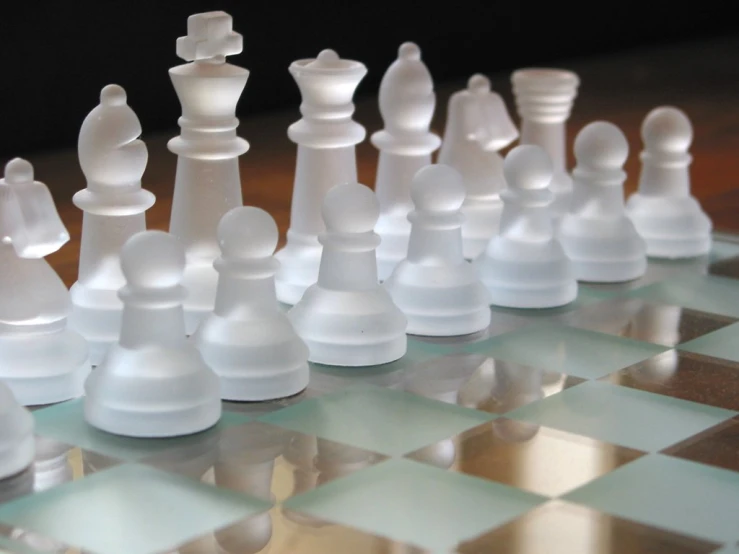 a chess board set with plastic white pieces